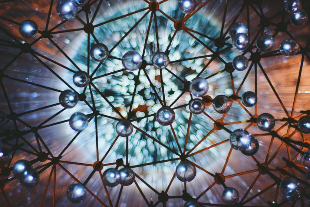 LoRaWAN Introduction, Futuristic geometric lighting installation at night, modern LED light art, innovative lighting design, creative illuminated sculpture, black metal framework with bright lights.