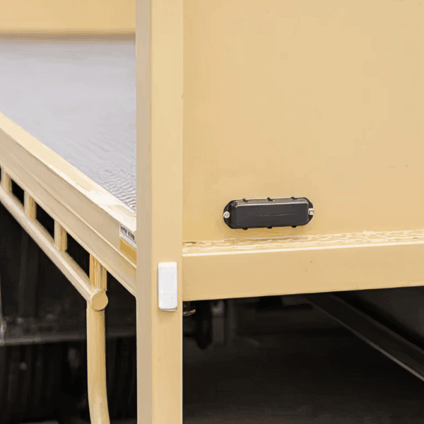 GPS tracking device attached to furniture for asset monitoring and security.
